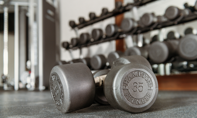 A set of 35lb dumbbells on the floor of a Hampton by Hilton fitness center.